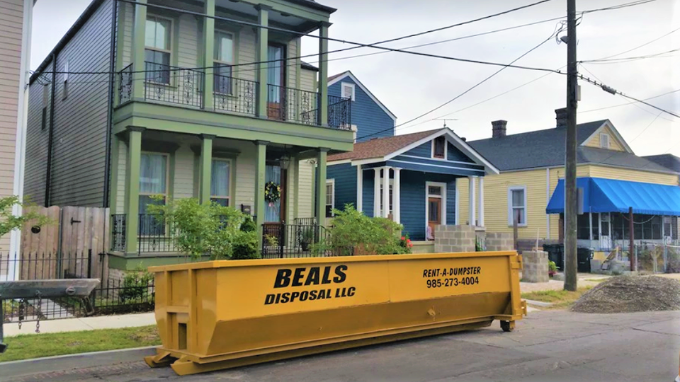 Yellow 20-yard Beals roll-off dumpster in Mandeville, Louisiana