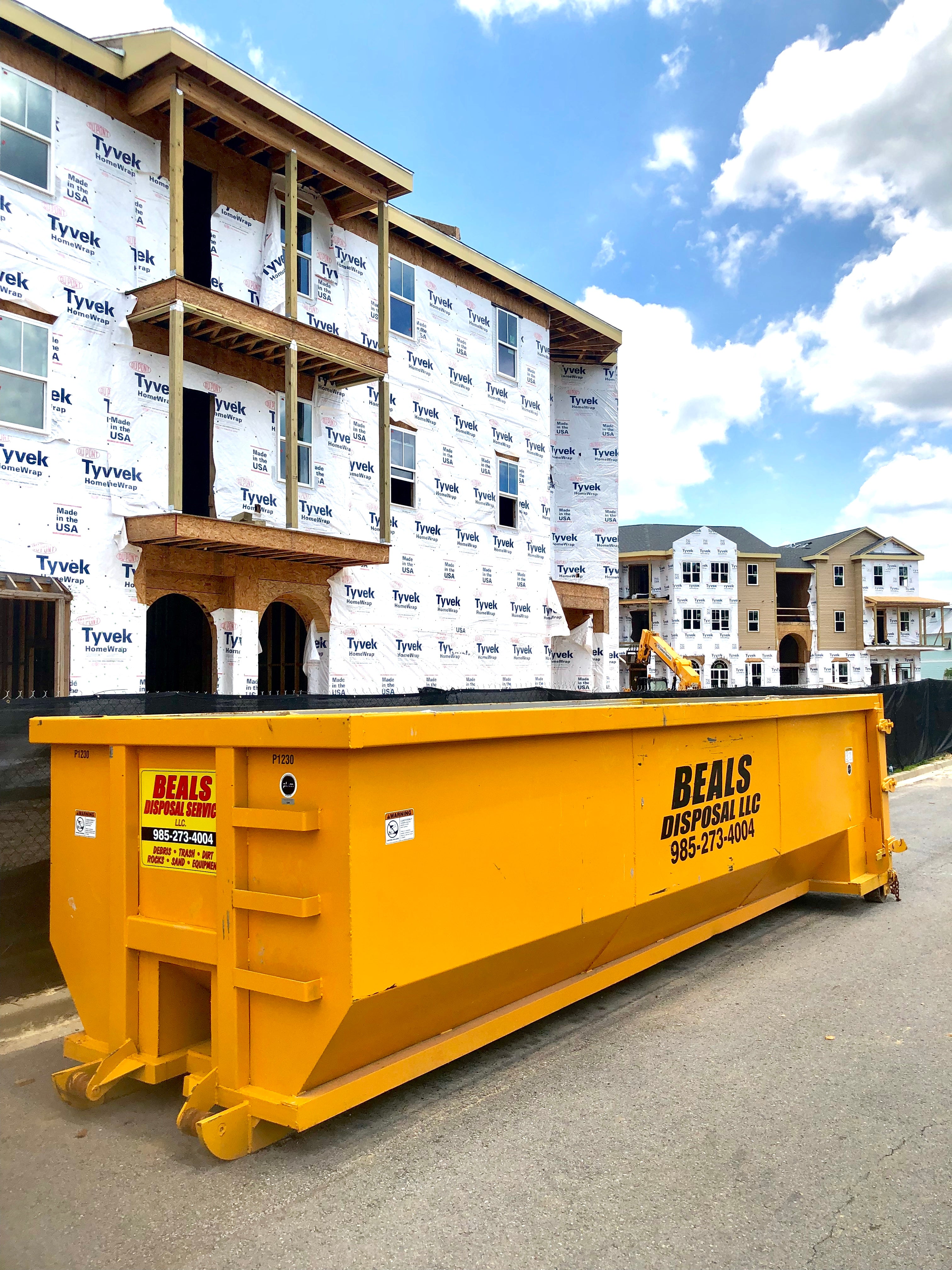Beals roll-off dumpster staged in front of an apartment building under construction